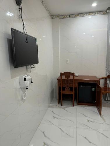a flat screen tv hanging on a wall in a room at Kiều Tiên Hotel in Long Thành