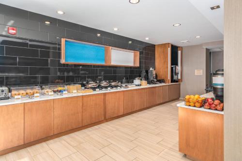 a hotel lobby with a buffet line with fruit on display at SpringHill Suites by Marriott Freeport Brunswick in Freeport