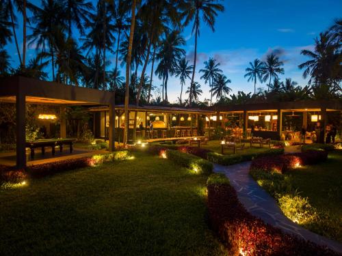 a resort with palm trees and lights at night at Ycona Eco-Luxury Resort, Zanzibar in Dikoni