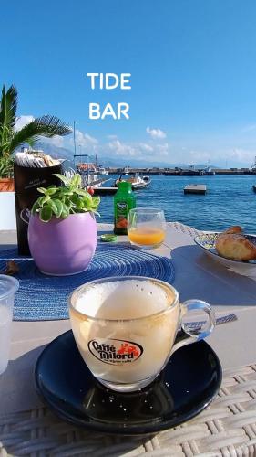 a table with a cup of coffee and a plate of food at The Sorabellas in Gaeta