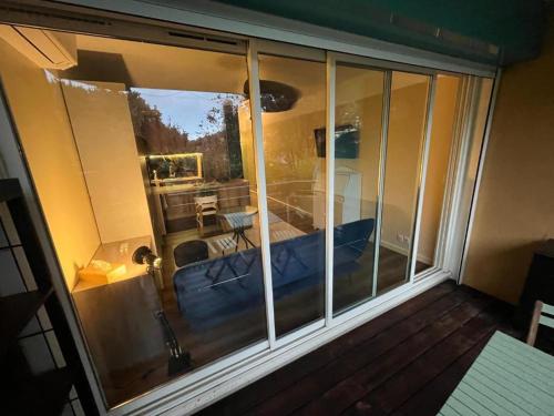 Cette chambre dispose d'un balcon avec vue sur un lit. dans l'établissement Le green bay piscine avec parking Pick up aéroport, à Roquebrune-Cap-Martin