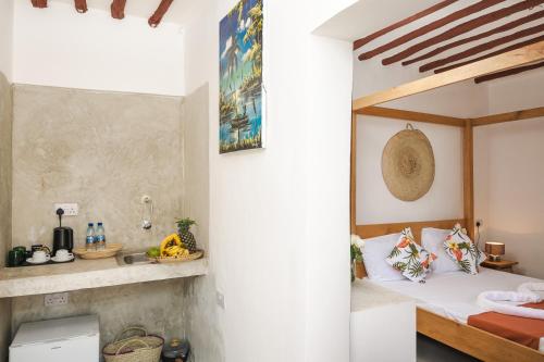 a bedroom with a bed and a sink in a room at Zanzibari holiday home by Liv Zanzibar in Paje