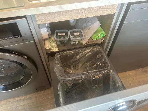 a drawer in a kitchen next to a washing machine at Buttermilk Lodge in Clifden