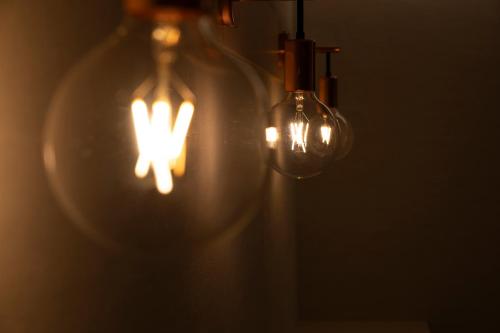 two light bulbs with a glowing cross in them at SAUNA&HOTEL Suuh スゥ in Takahagi