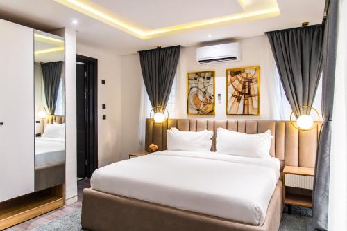 a hotel room with a bed and a mirror at George Residence Lekki in Lekki