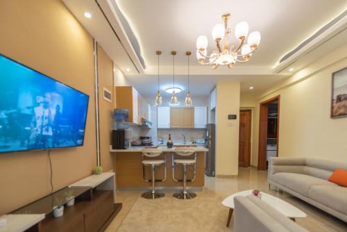 a living room with a couch and a tv at Exquisite Condo with Free parking Gym and Pool in Nairobi