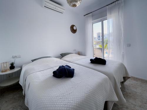 two beds in a white room with towels on them at Rd02 La Casa Hermosa in Torrox