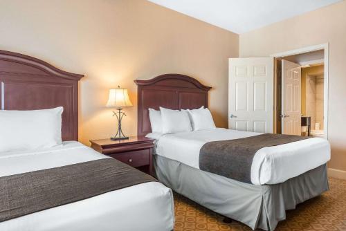 a hotel room with two beds and a lamp at Bluegreen Vacations Fountains, an Ascend Collection Resort in Orlando
