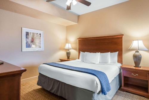 a hotel room with a large bed and two lamps at Bluegreen Vacations Fountains, an Ascend Collection Resort in Orlando