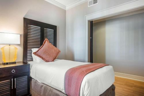 a bedroom with a bed and a lamp on a table at Bluegreen Vacations Fountains, an Ascend Collection Resort in Orlando