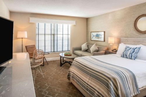 a hotel room with a bed and a couch at Edgar Hotel Martha's Vineyard, an Ascend Collection Hotel in Edgartown