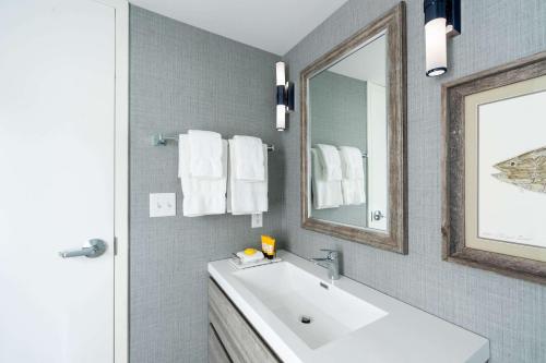 a bathroom with a white sink and a mirror at Edgar Hotel Martha's Vineyard, an Ascend Collection Hotel in Edgartown