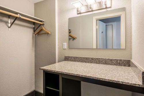 a bathroom with a sink and a mirror at Hotel Bothwell Sedalia Central District, an Ascend Collection Hotel in Sedalia