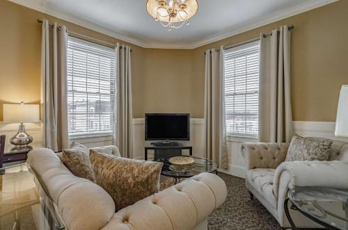 a living room with a couch and a tv at Hotel Bothwell Sedalia Central District, an Ascend Collection Hotel in Sedalia