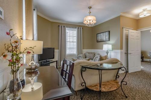a living room with a couch and a table at Hotel Bothwell Sedalia Central District, an Ascend Collection Hotel in Sedalia