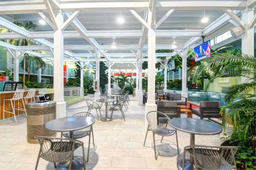 a patio with tables and chairs in a restaurant at Oasis Hotel and Conv Center, an Ascend Collection Hotel in Springfield