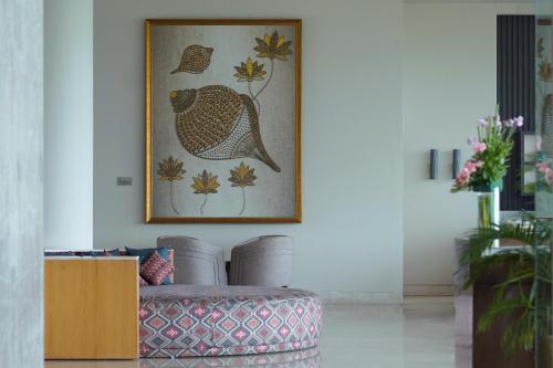 a living room with a picture of a bird on the wall at Welcomhotel By ITC Hotels, Katra in Katra