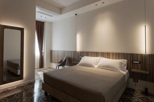 a hotel room with a bed and a mirror at Dimora Don Minzoni in Matera