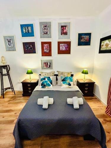 a bedroom with a large bed with blue sheets and pillows at XL Massive Art-Filled Home in Central Area, WALK to Sliema, St Julian's in Il-Gżira