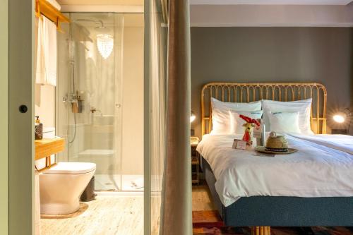 a bedroom with a bed and a bathroom with a shower at Bikini Island & Mountain Port de Soller "Adults only" in Port de Soller