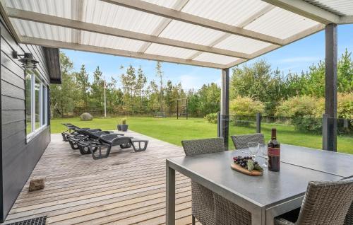 a patio with a table and chairs on a deck at Holiday Home Jerup With Fireplace I in Jerup