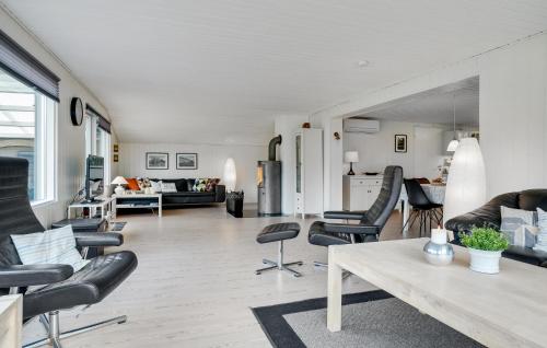 a living room with black chairs and a table at Holiday Home Jerup With Fireplace I in Jerup