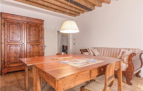 a dining room with a wooden table and a couch at Casa Giu in Pacengo di Lazise