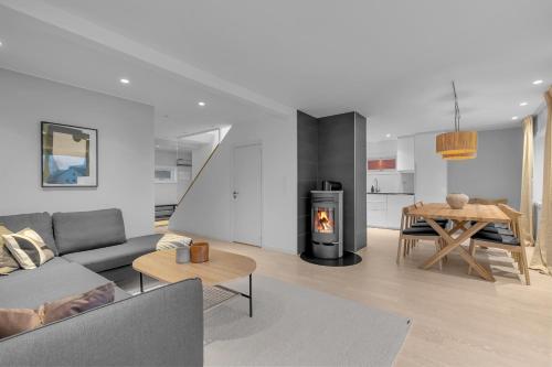a living room with a couch and a fireplace at Northstay - The Arctic Pearl, Central House with 4 bedrooms and 2 bathrooms in Tromsø