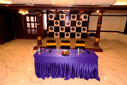 a purple table with chairs in a room with a flag at Zip by Spree Hotels Mangala International in Coimbatore