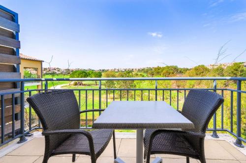 a patio with a table and chairs on a balcony at Zenitude Hotel la Valadière, an Ascend Collection Hotel in Montpellier