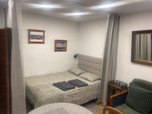 a small bedroom with a bed and a chair at Estudio T41 - City Historic Center in Lisbon