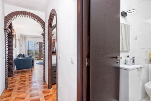 a hallway with a door leading to a bathroom at F04 Bahia Playa - Apartment in Mijas Costa