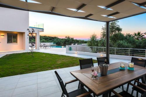 a patio with a wooden table and chairs on a patio at Estel Residences in Chania Town