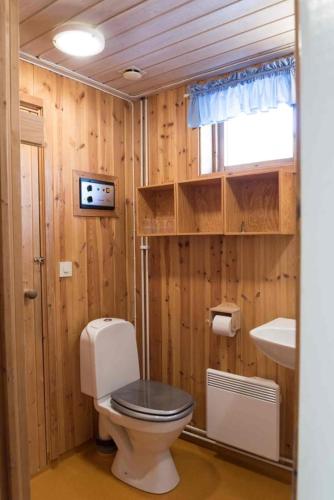 a wooden bathroom with a toilet and a sink at Sauna | Terrace | Engine heater | Pets allowed in Lofsdalen