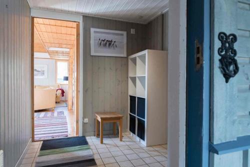 a hallway with a table and a door to a room at Sauna | Terrace | Engine heater | Pets allowed in Lofsdalen