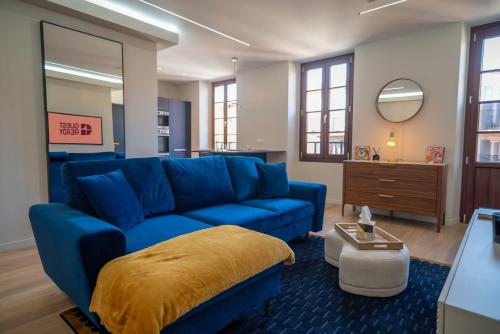 un salon avec un canapé bleu et un miroir dans l'établissement GuestReady - Lovely Getaway, à Nice