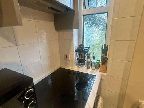 a kitchen with a counter with a window in it at Buttermilk Lodge in Clifden