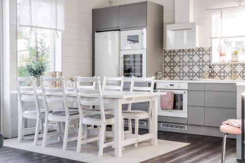 a kitchen with a white table and white chairs at Close to ski slopes | Sauna | WiFi | Terrace in Lofsdalen