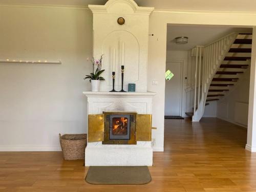 a fireplace in the middle of a living room at Cosy villa near forest and lake in Osby