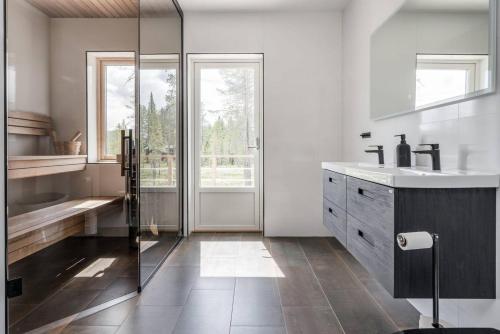 a bathroom with a sink and a glass shower at Sauna | Wi-Fi | Pets allowed | Dryer in Lofsdalen