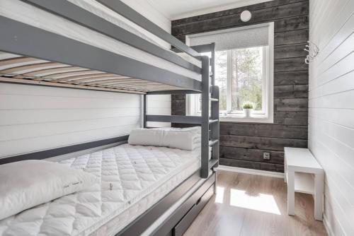 a bedroom with two bunk beds and a window at Sauna | Wi-Fi | Pets allowed | Dryer in Lofsdalen