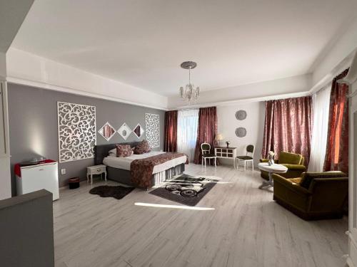 a bedroom with a bed and a living room at Hotel ZEN-Aeroport in Craiova