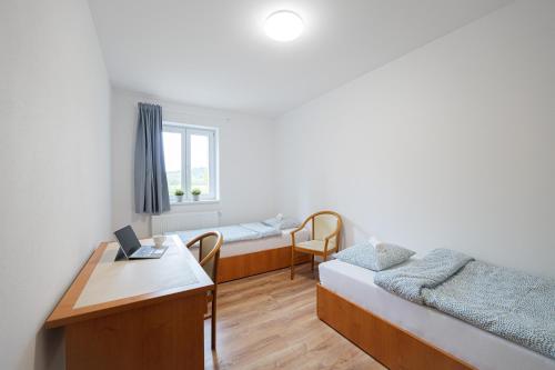 a hospital room with two beds and a desk at TVM Ostrava 1 in Ostrava
