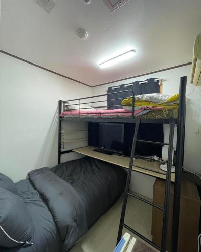 a dorm room with a bunk bed and a bunk bed gmaxwell gmaxwell gmaxwell at GwangJu SunFlower Hostel in Gwangju
