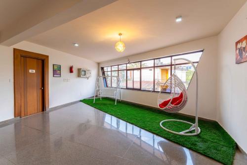 a living room with a hammock in the middle of the room at Treebo Regalia Comforts, 15 Mins From Abbey Waterfall in Madikeri