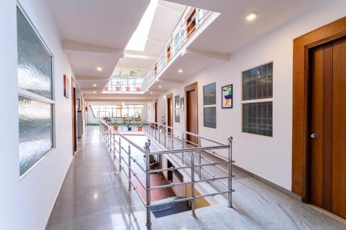 a hallway with a staircase in a building at Treebo Regalia Comforts, 15 Mins From Abbey Waterfall in Madikeri