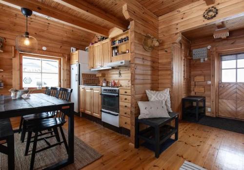a kitchen with wooden walls and a table and chairs at Ski-in/Ski-out | Sauna | Pets allowed | Terrace in Lofsdalen