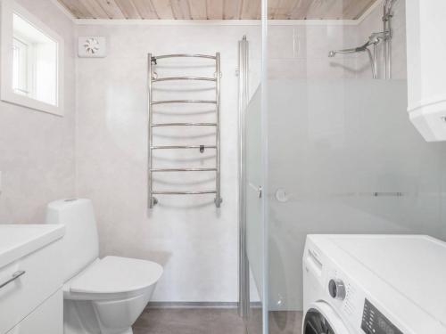 a white bathroom with a toilet and a shower at Fishing area | Wi-Fi 100/100 | Terrace | Washing machine in Lofsdalen