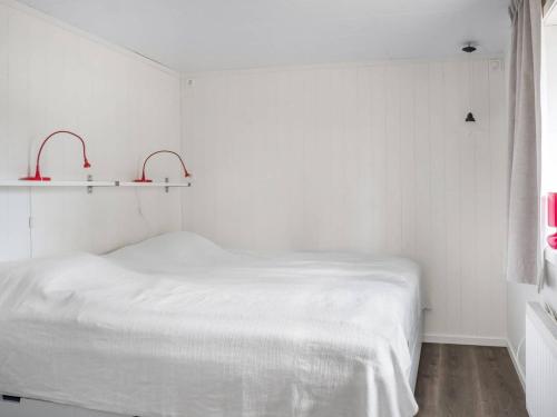 a white room with a bed and two shelves at Fishing area | Wi-Fi 100/100 | Terrace | Washing machine in Lofsdalen