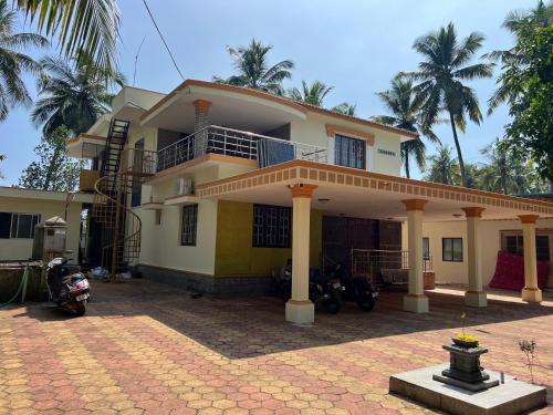 a house with motorcycles parked in front of it at Zeno Villa Malpe - Premium Villa in Malpe